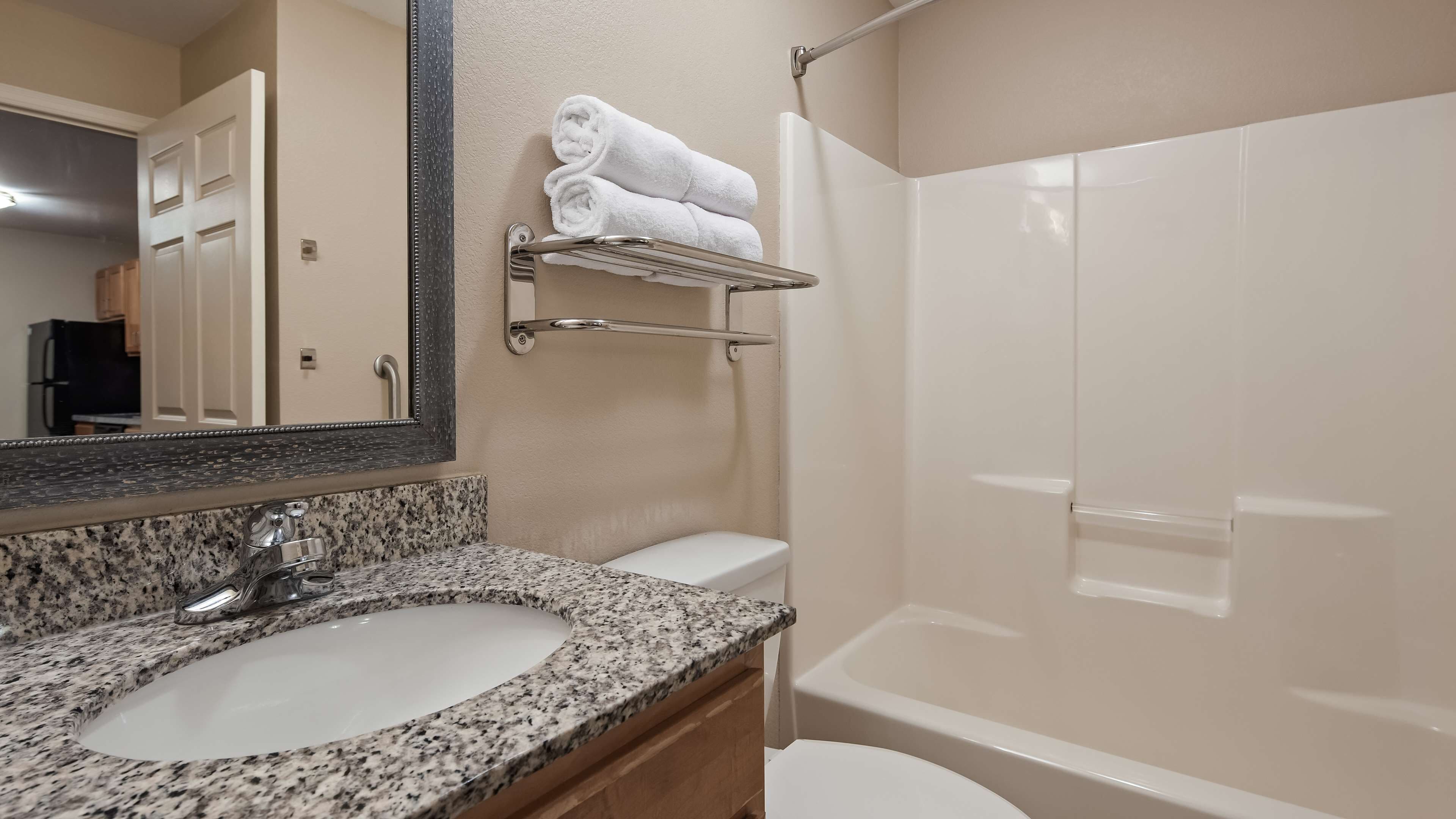 suite, 1 king bed, non smoking, kitchenette | bathroom | combined shower/bathtub, free toiletries, hair dryer, towels