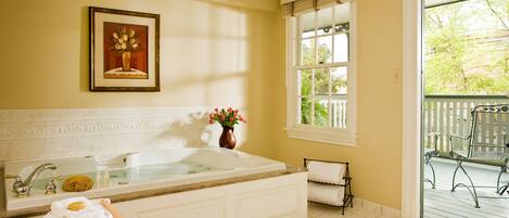 A bathroom with a bathtub, a sink, and a window.