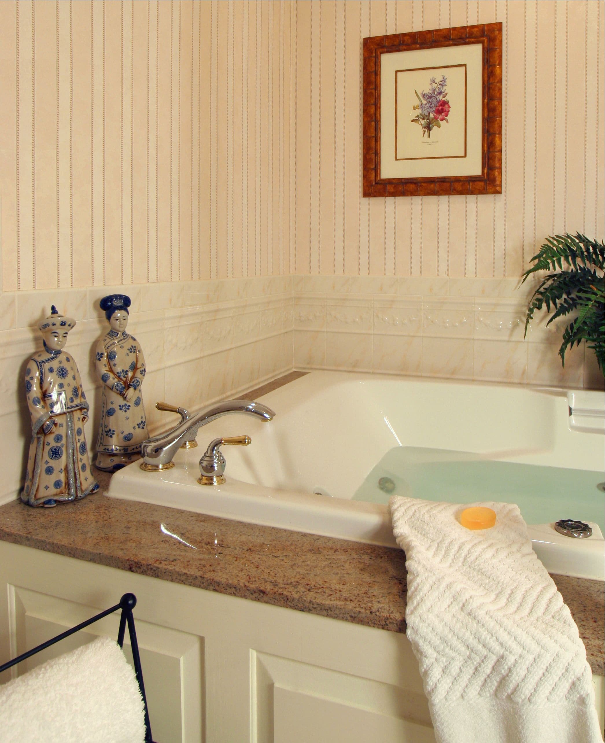 A bathroom with a sink, a bathtub, and decorative items on the counter.