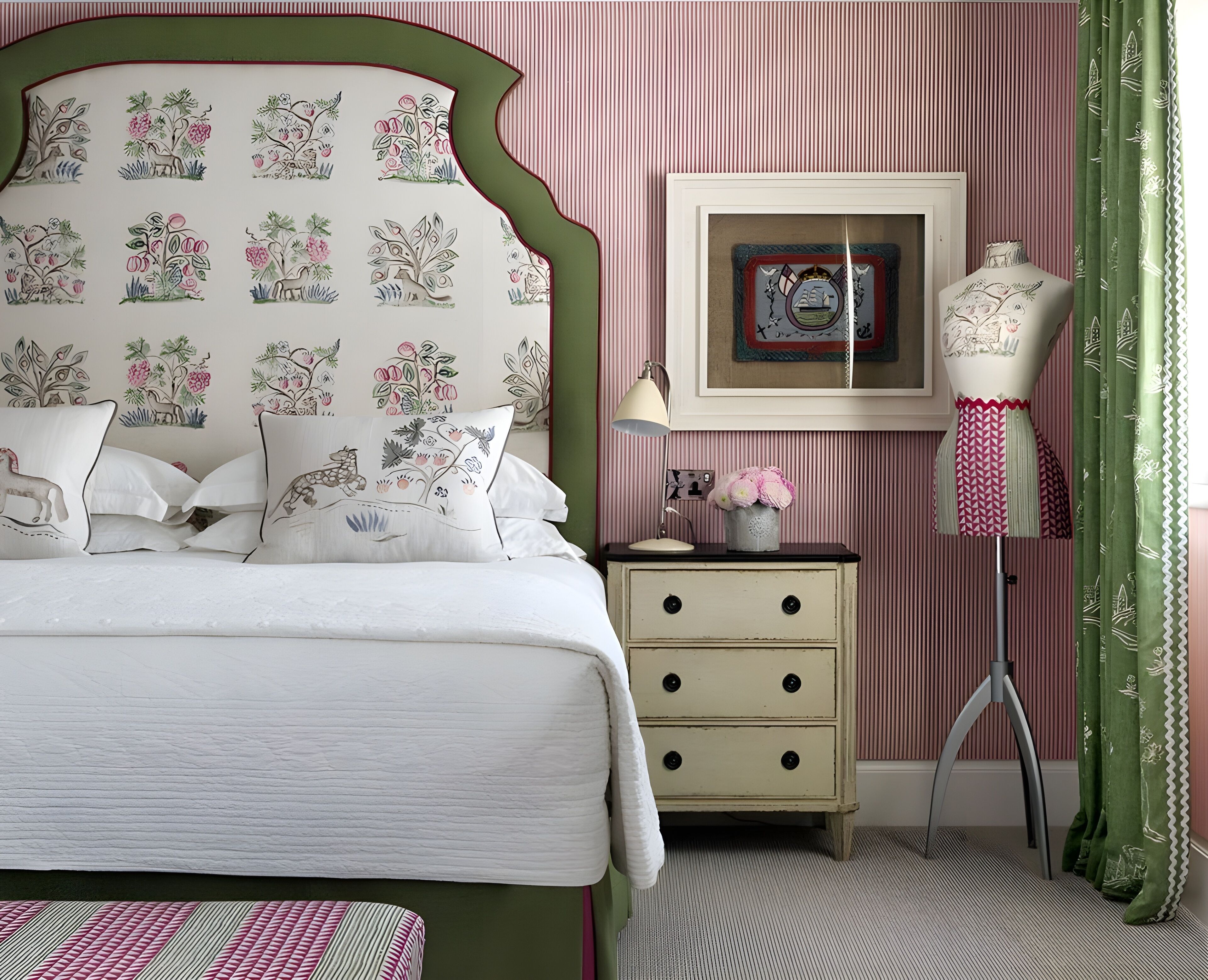 A bedroom with a bed, a dresser, a nightstand, a lamp, a framed picture, and a mannequin.
