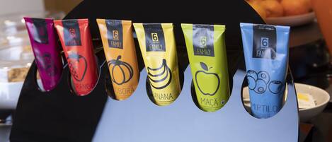 A display of six beverage packets with different fruit designs.