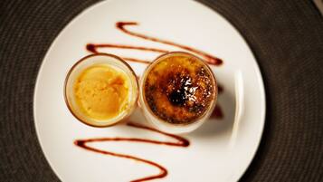 A dessert on a white plate with a dark background.
