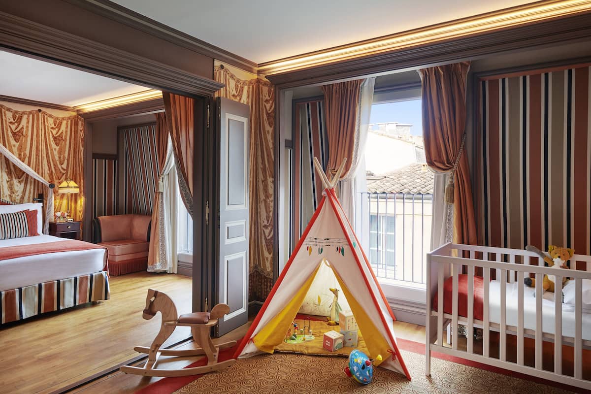A child's play area with a tent, rocking horse, and toys.