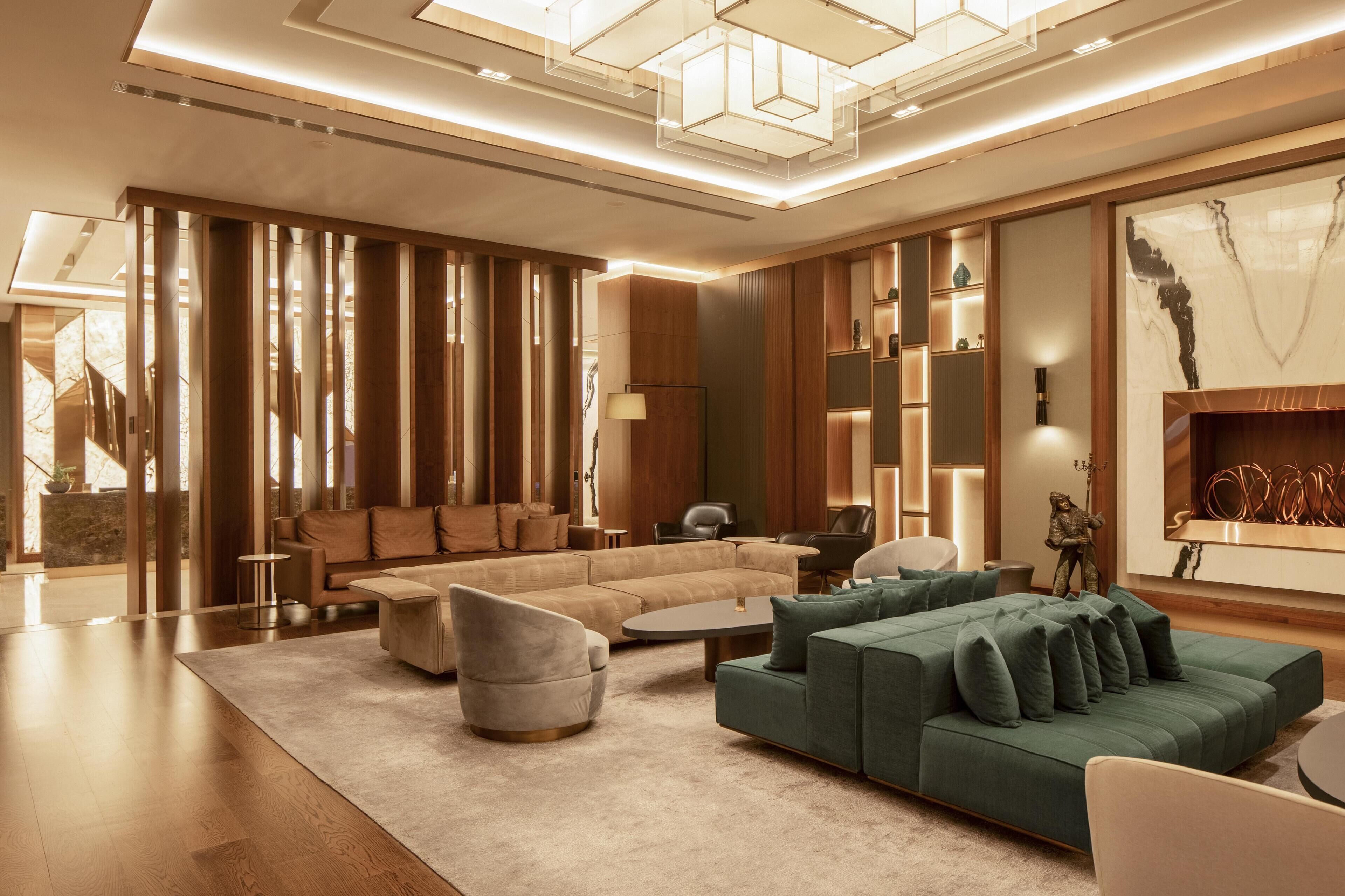 A modern living room with a sectional sofa, a chaise lounge, and a coffee table.