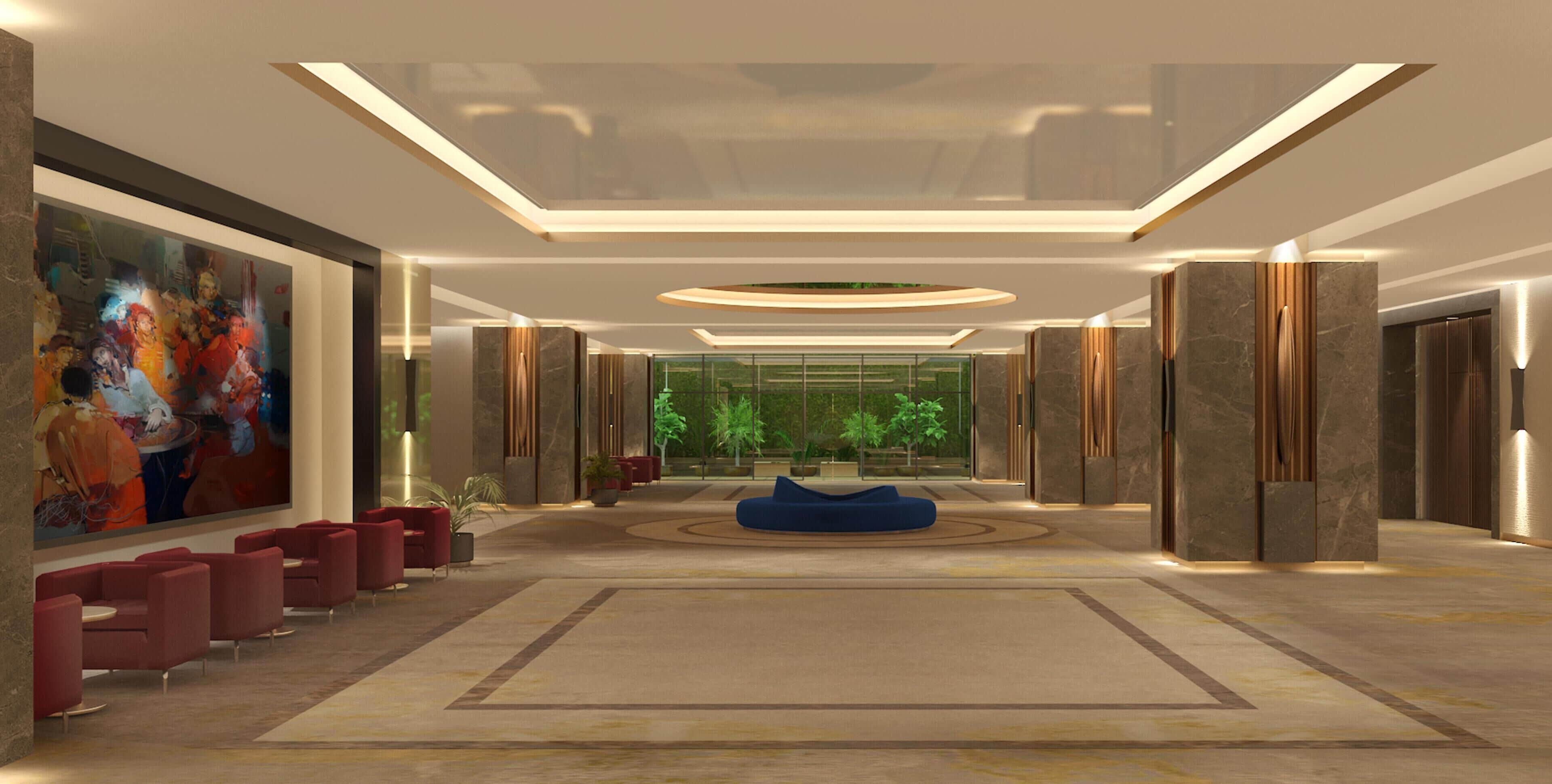 A spacious lobby with a large painting, red seating, a blue sofa, and a view through the glass wall.