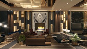 A modern interior with a fireplace, sofas, armchairs, and a bookshelf. - Hilton Istanbul Maslak (Sariyer)