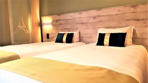 A hotel room with two beds, each with a wooden headboard and white bedding. - Euro Hôtel Paris Créteil (Creteil)
