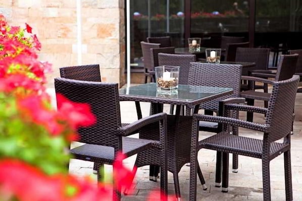 Outdoor wicker furniture with glass tops, arranged around tables. - Lion Borovetz (Samokov)