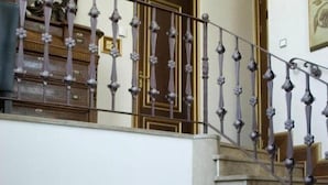 A grand staircase with ornate balustrades leading to an upper floor. - Sultan Inn Boutique (Baku)