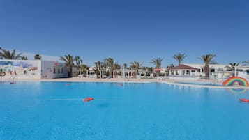 Relax by the pool surrounded by palm trees and enjoy a refreshing swim.