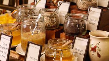 A display of jars with labels such as 'Orange Marmalade' and 'Poppy Seeds'.