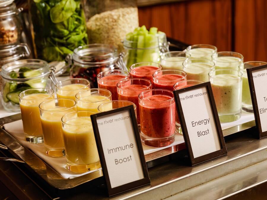 A buffet with various smoothie options labeled as Immune Boost, Energy Blast, and Toxin Eliminator.