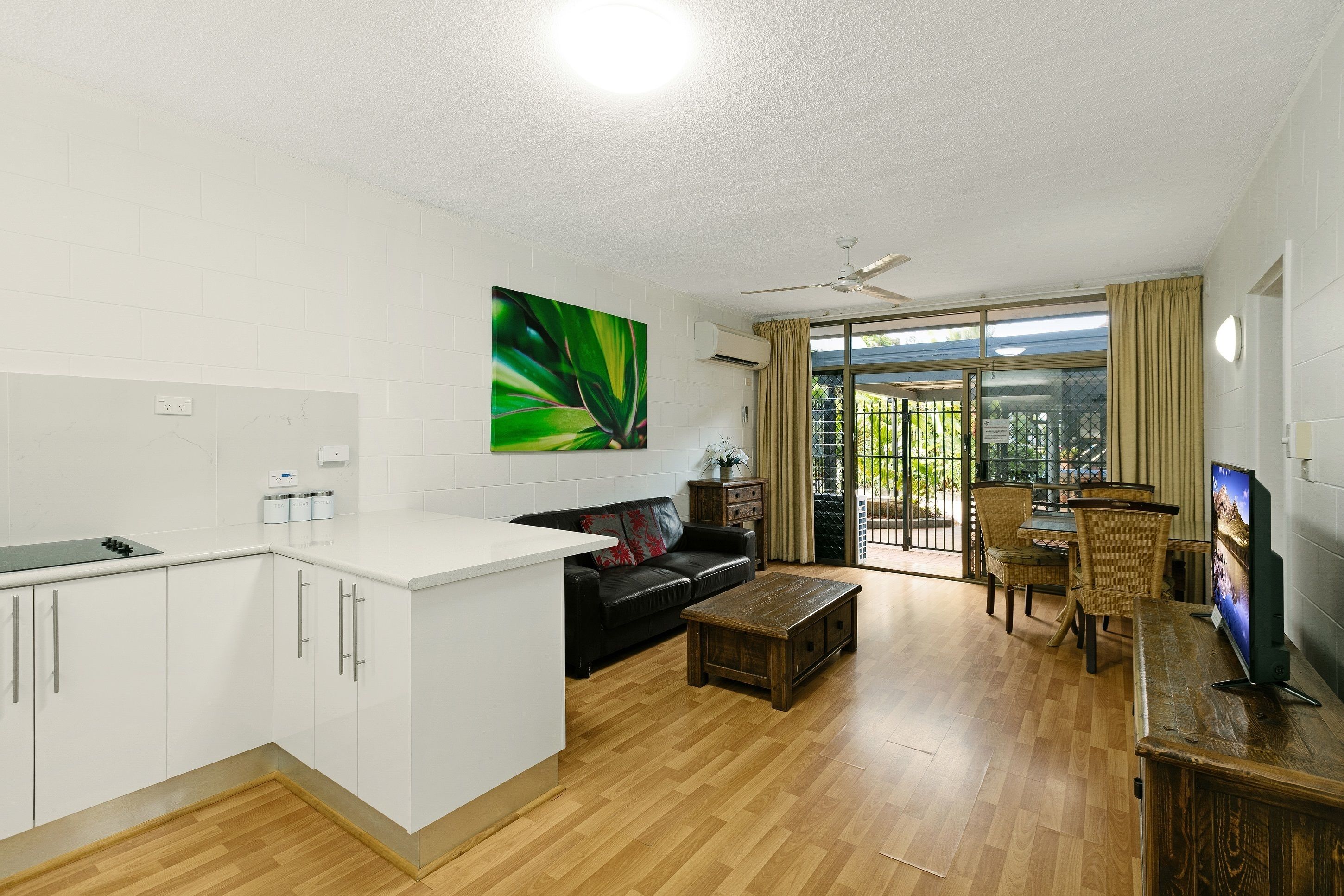 A modern apartment with a kitchen, living area, and balcony.
