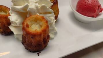 A dessert plate with éclairs and a scoop of ice cream.