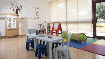 Children can play and learn in this well-designed space with a play area, bookshelf, and table for activities.