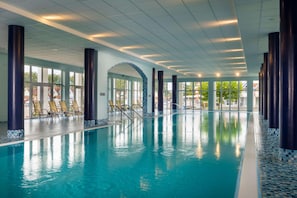 Una piscina cubierta, tumbonas