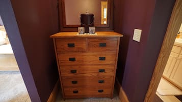 A wooden dresser with multiple drawers and a coffee maker on top.