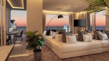 Luxury Suite | Living area | 50-inch Smart TV with cable channels