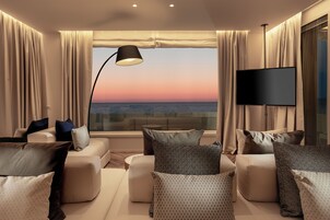 Luxury Suite | Living area | 50-inch Smart TV with cable channels
