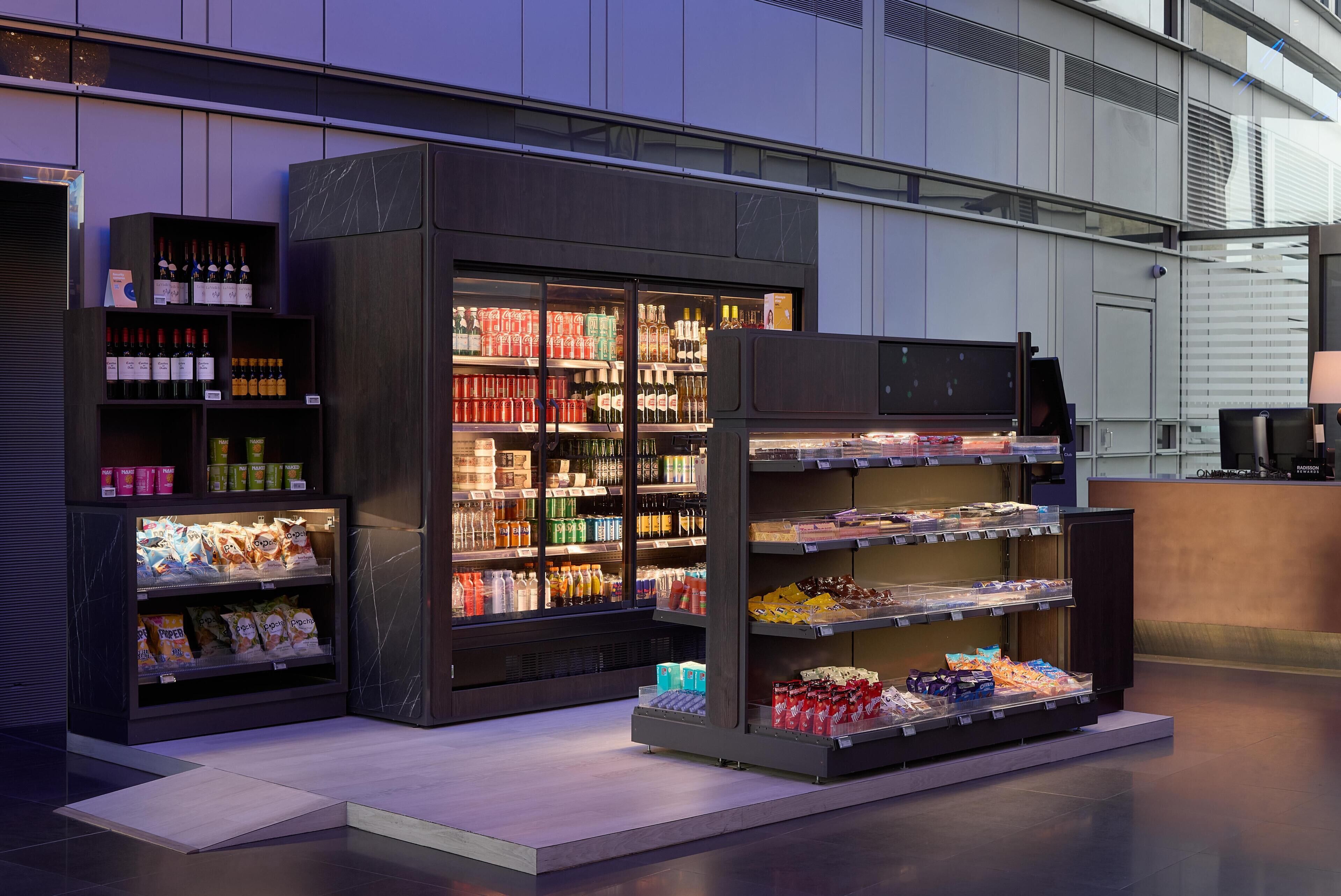 A modern retail display with shelves of bottled beverages and snacks.