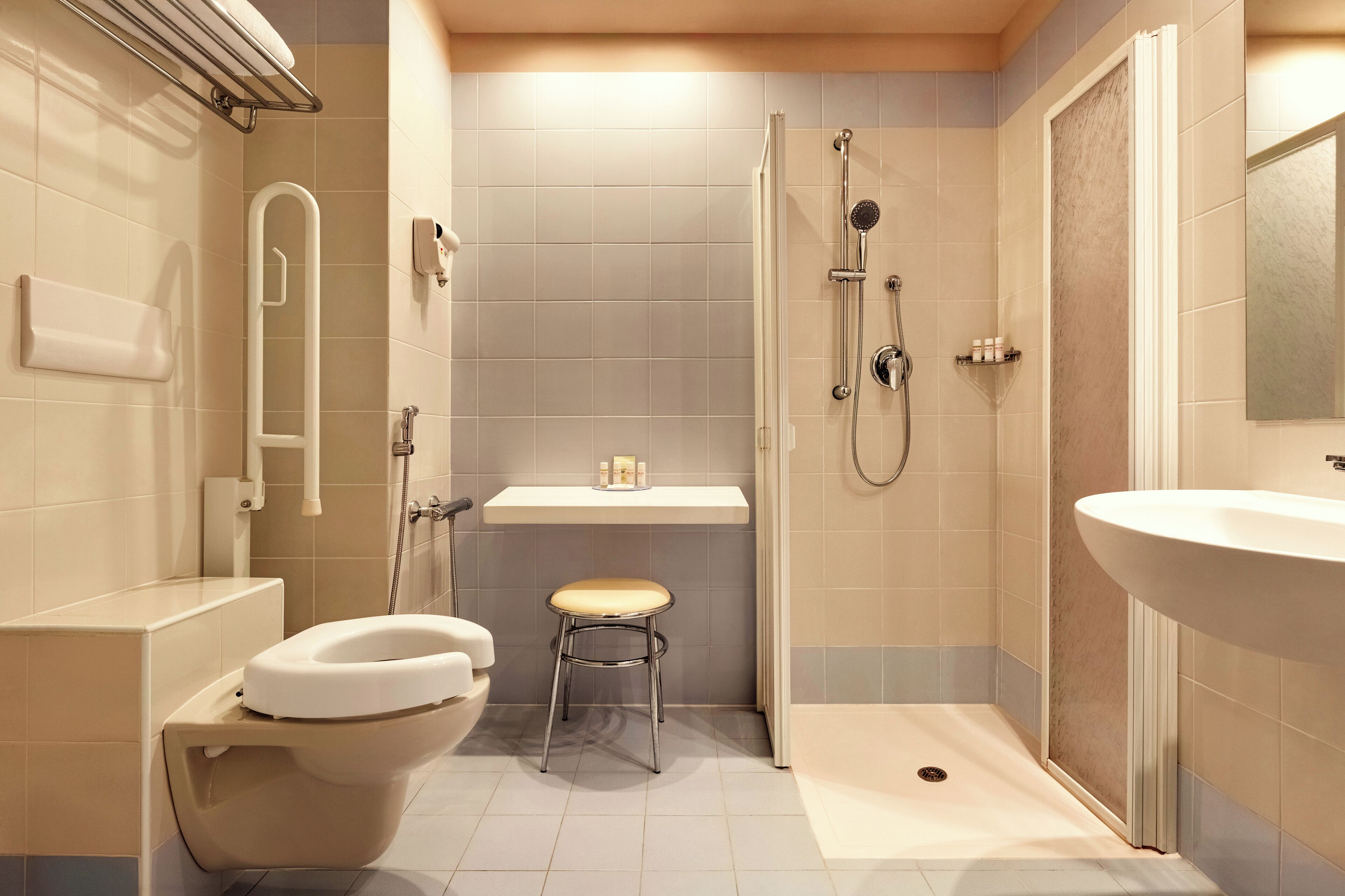A modern bathroom with a toilet, sink, and shower.