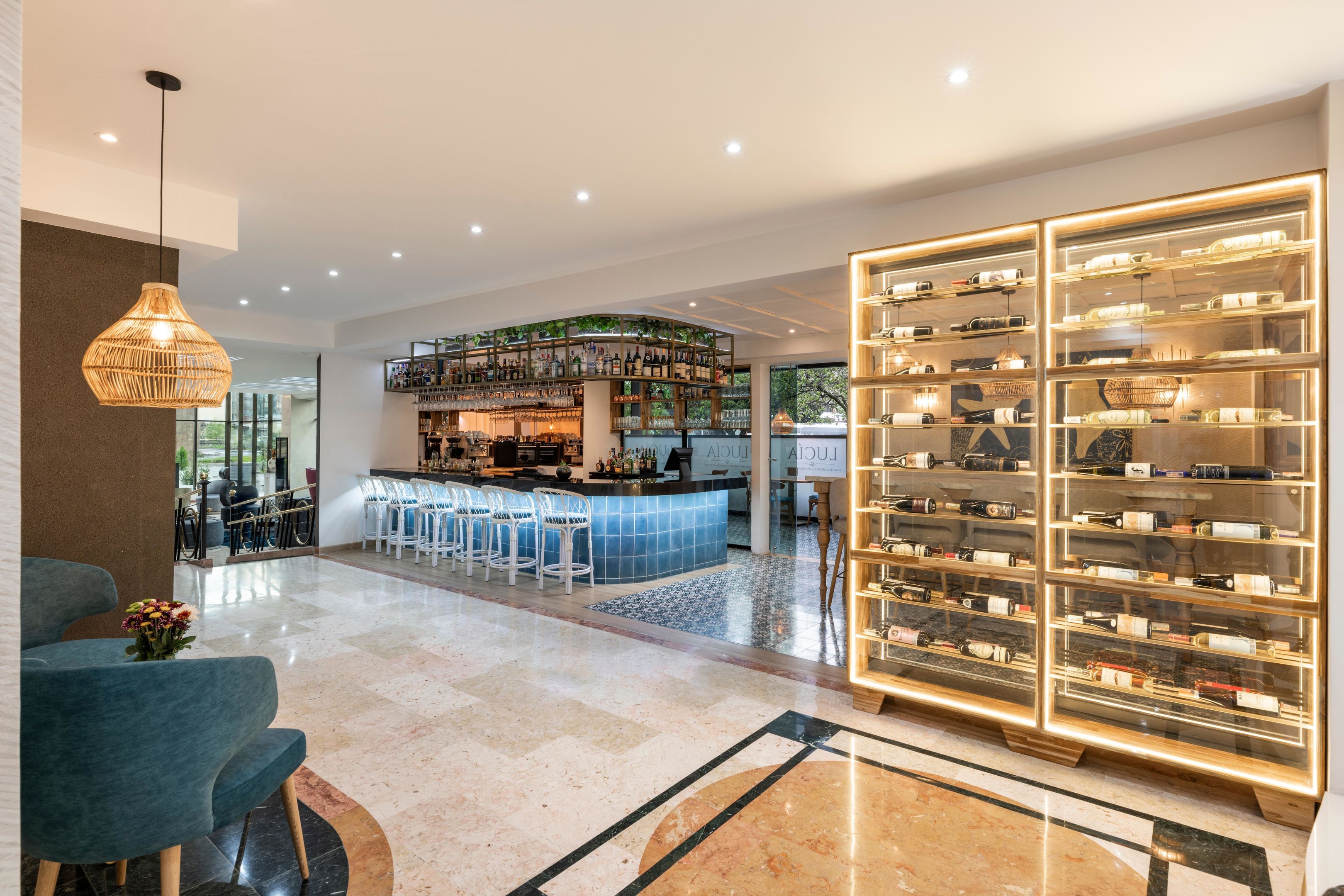 A modern bar area with a curved counter and multiple seating options.