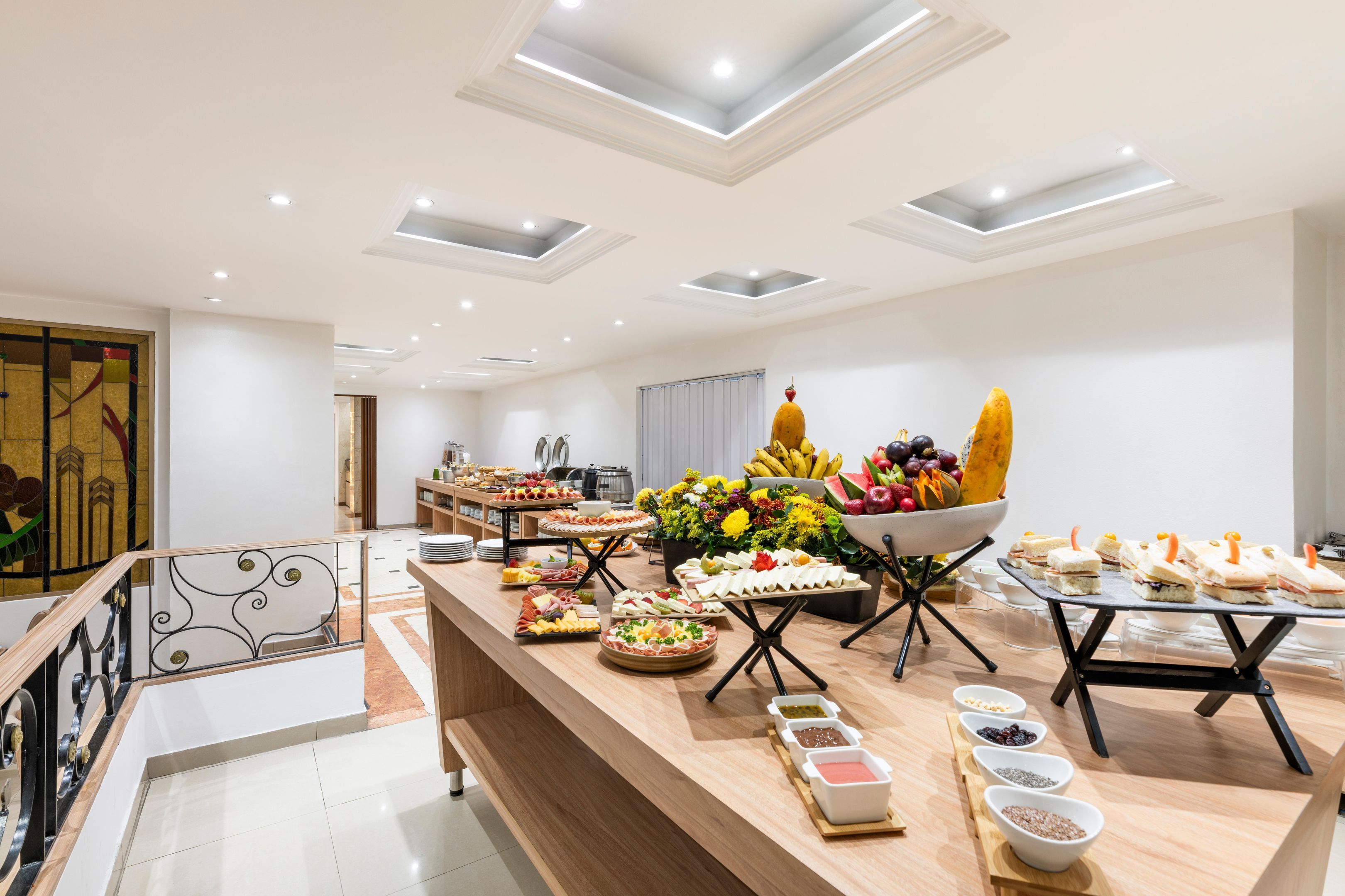 A buffet setup with various food items and condiments.