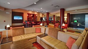 A modern lobby with a seating area, a bar, and a boarding pass sign. - Courtyard by Marriott Wall at Monmouth Shores Corporate Park (Neptune City)