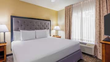 Premium bedding, desk, laptop workspace, blackout curtains