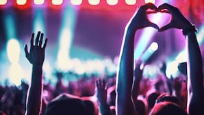 A crowd at a concert with raised hands and a heart shape made by two hands. - Holiday Inn Express & Suites Corona by IHG (Corona)