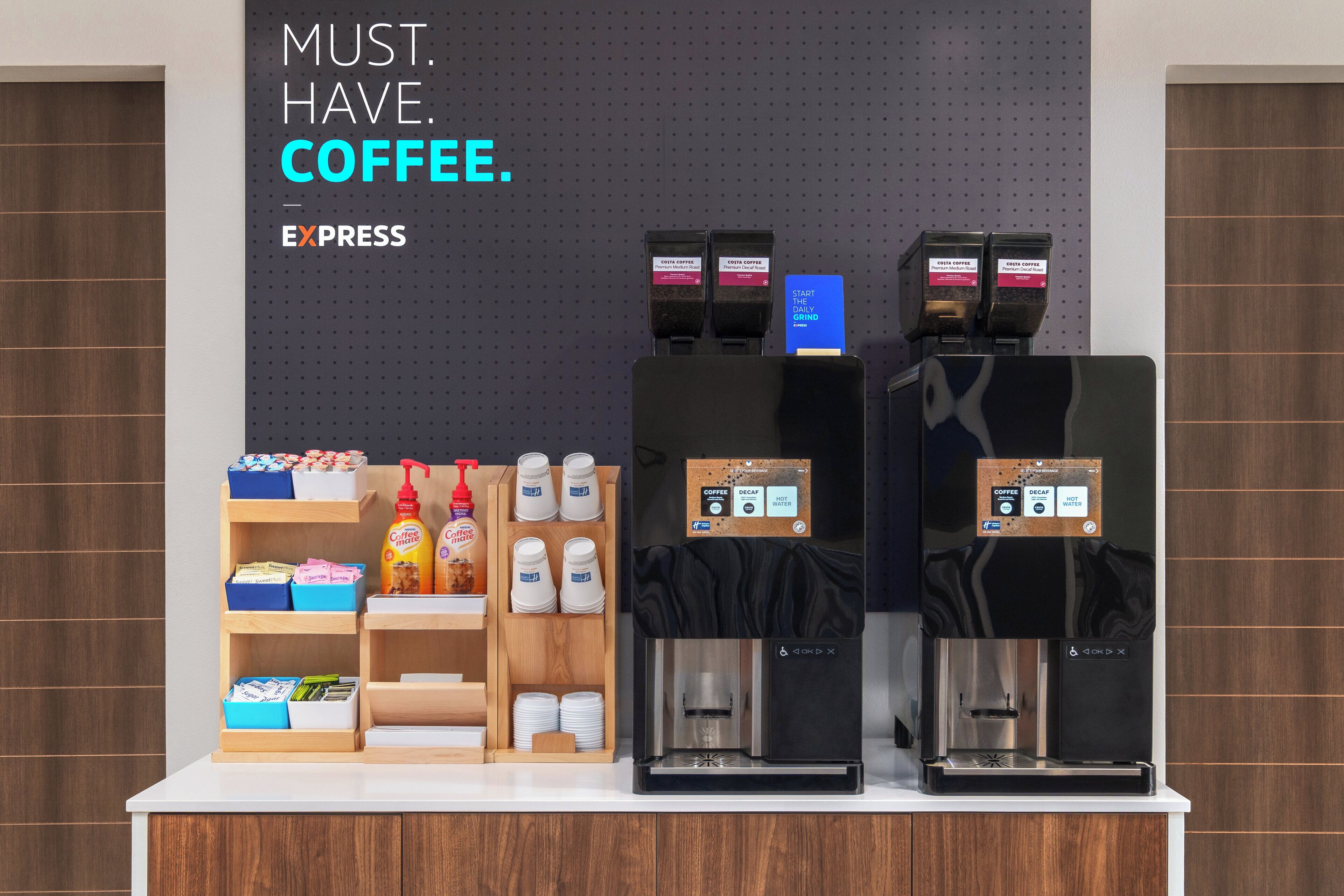 A coffee station with branded dispensers and a variety of coffee products.