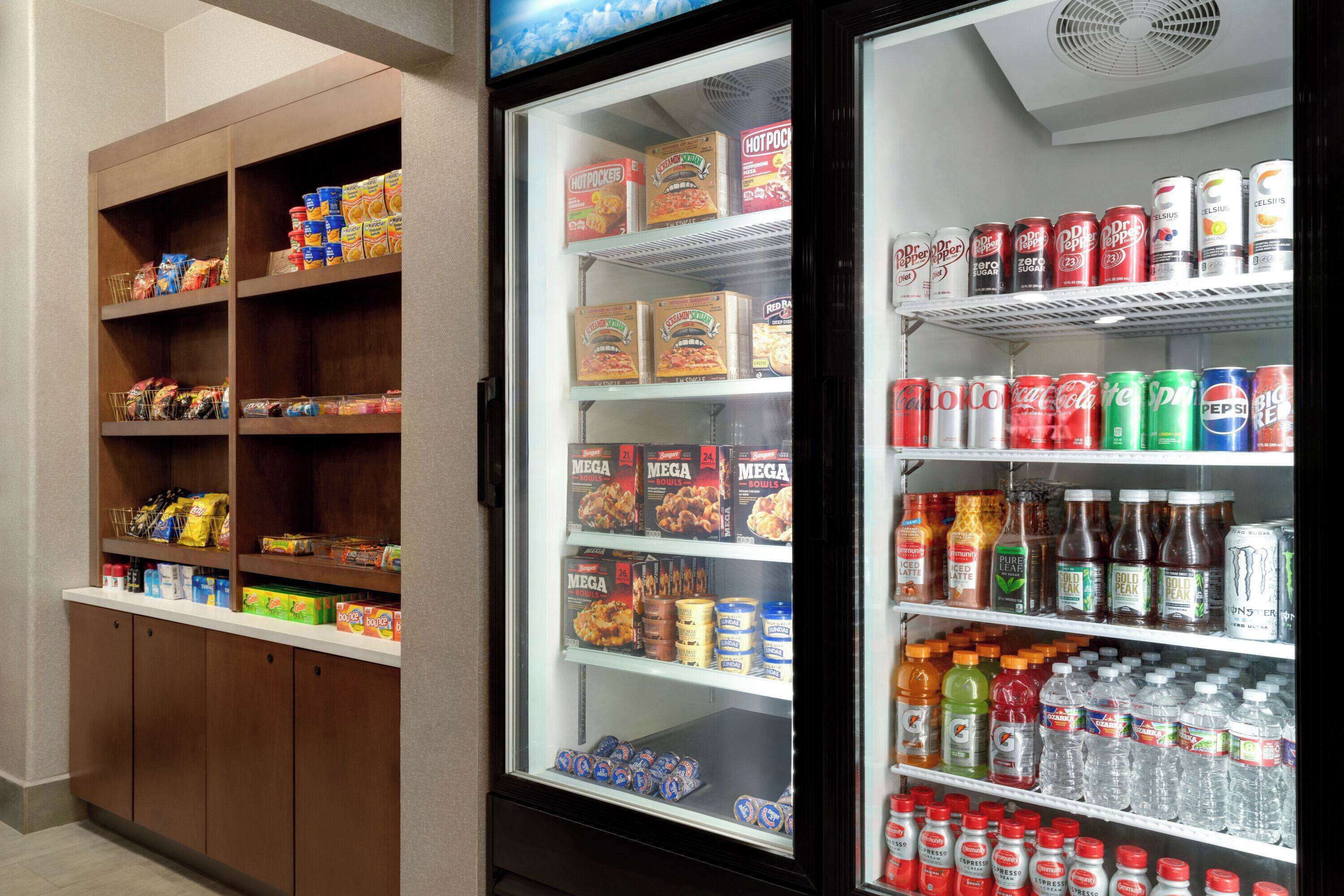 A vending machine stocked with snacks, drinks, and beverages.