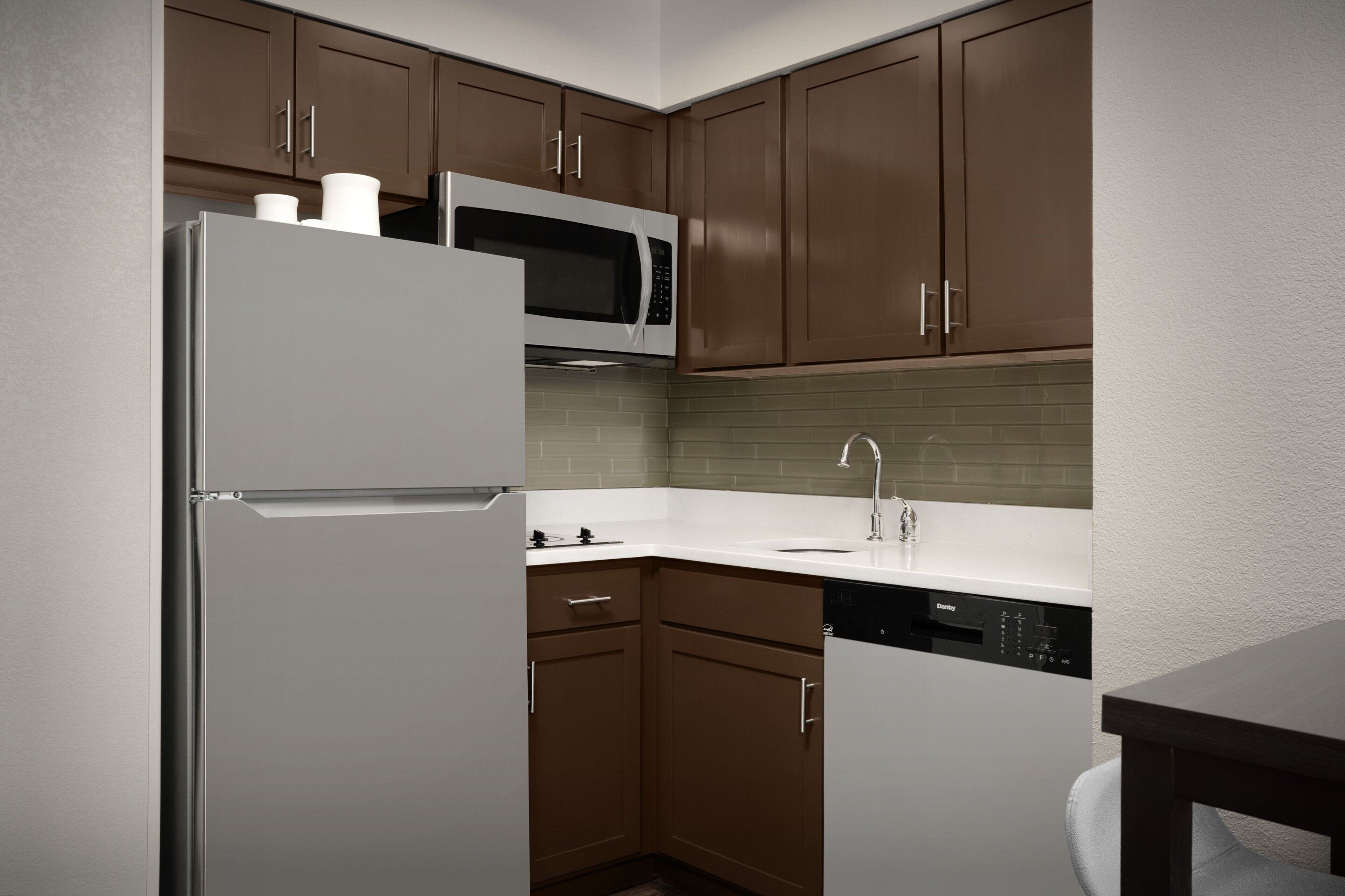 full-sized fridge, microwave, stovetop, dishwasher