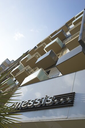 A hotel with a modern design, featuring a prominent 'Manessis' sign and multiple balconies. - Anessis Hotel (Thessaloniki)
