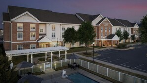 A hotel with a covered outdoor area, a swimming pool, and a parking lot. - TownePlace Suites by Marriott Suffolk Chesapeake (Suffolk)