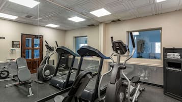 A gym with treadmills, an elliptical, and a weight bench.