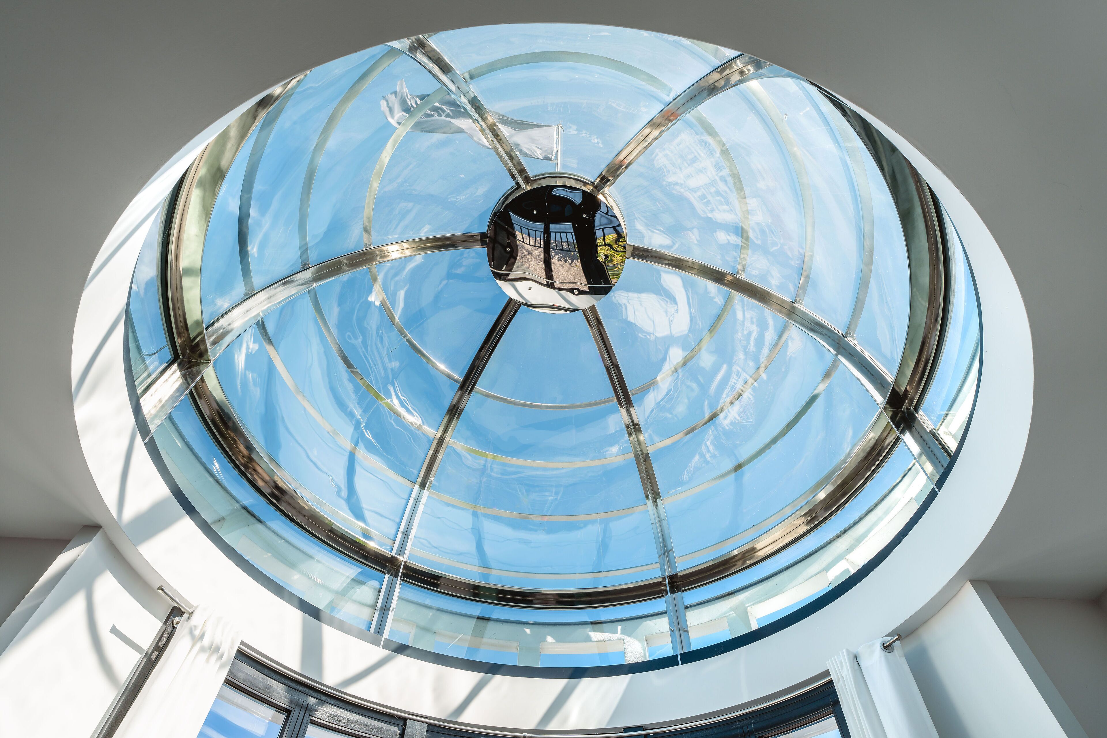 A large, circular skylight with a glass dome structure.