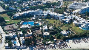An aerial view of a resort with multiple buildings, a large pool, and a beach area. - Hasdrubal Thalassa Port El Kantaoui (Port El Kantaoui)