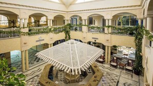A multi-level atrium with a central open space, balconies with greenery, and seating areas. - Hasdrubal Thalassa Port El Kantaoui (Port El Kantaoui)