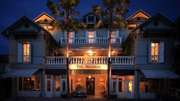 A two-story building with a balcony, palm trees, and a sign that reads "The Regency." - The Eugenia Hotel & Spa (Bangkok)