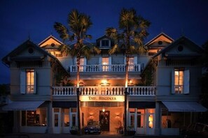 A two-story building with a balcony, palm trees, and a sign that reads "The Regency." - The Eugenia Hotel & Spa (Bangkok)