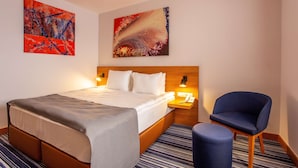 A hotel room with a bed, a chair, and two paintings on the wall. - Best Western Terminus Hotel (Sofia)