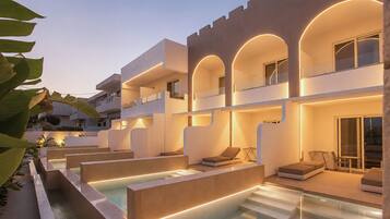 A modern building with a pool area, outdoor seating, and a staircase leading to the upper levels.