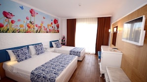 A hotel room with two beds, a TV, a desk, and a painting of flowers on the wall. - Eftalia Village Hotel - All Inclusive (Alanya)
