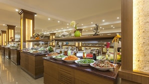 A buffet with various food items and decorative elements like flowers and sculptures. - Eftalia Village Hotel - All Inclusive (Alanya)