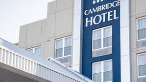 A modern building with a prominent sign for Cambridge Hotel and a Conference Centre.