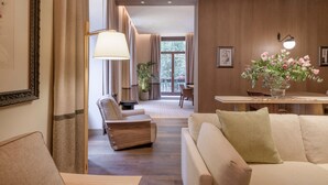 Una sala de estar moderna con un sofá, un sillón y un comedor con mesa y sillas.