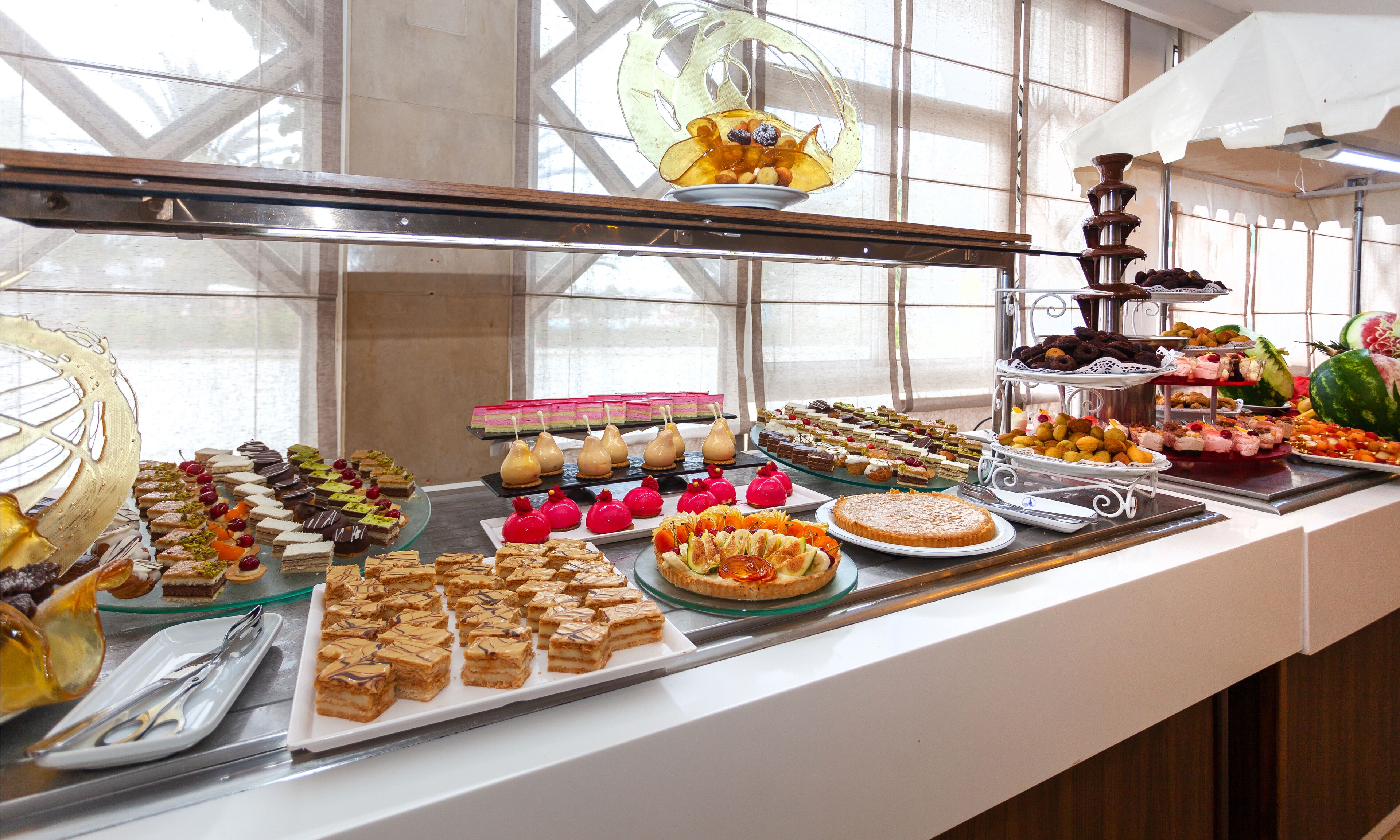 A buffet with various desserts and pastries.