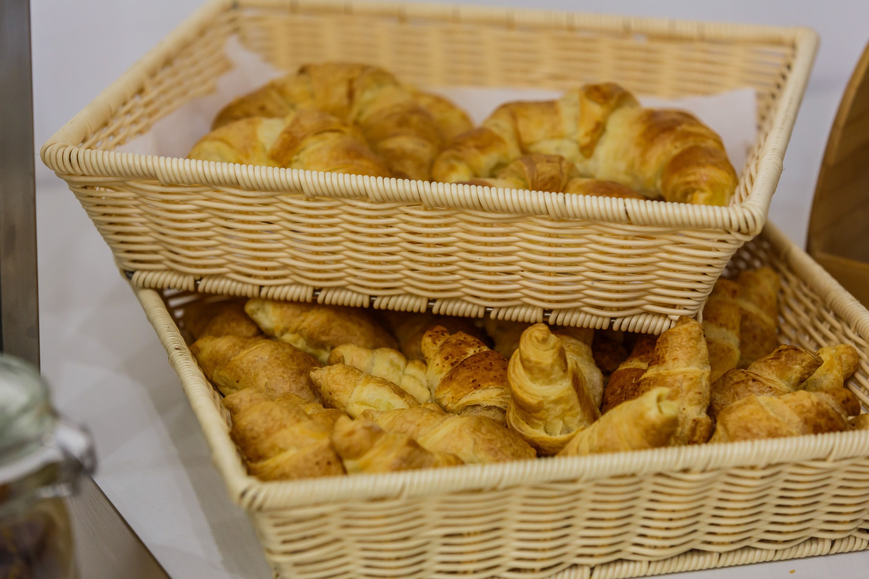 A wicker basket filled with assorted pastries.