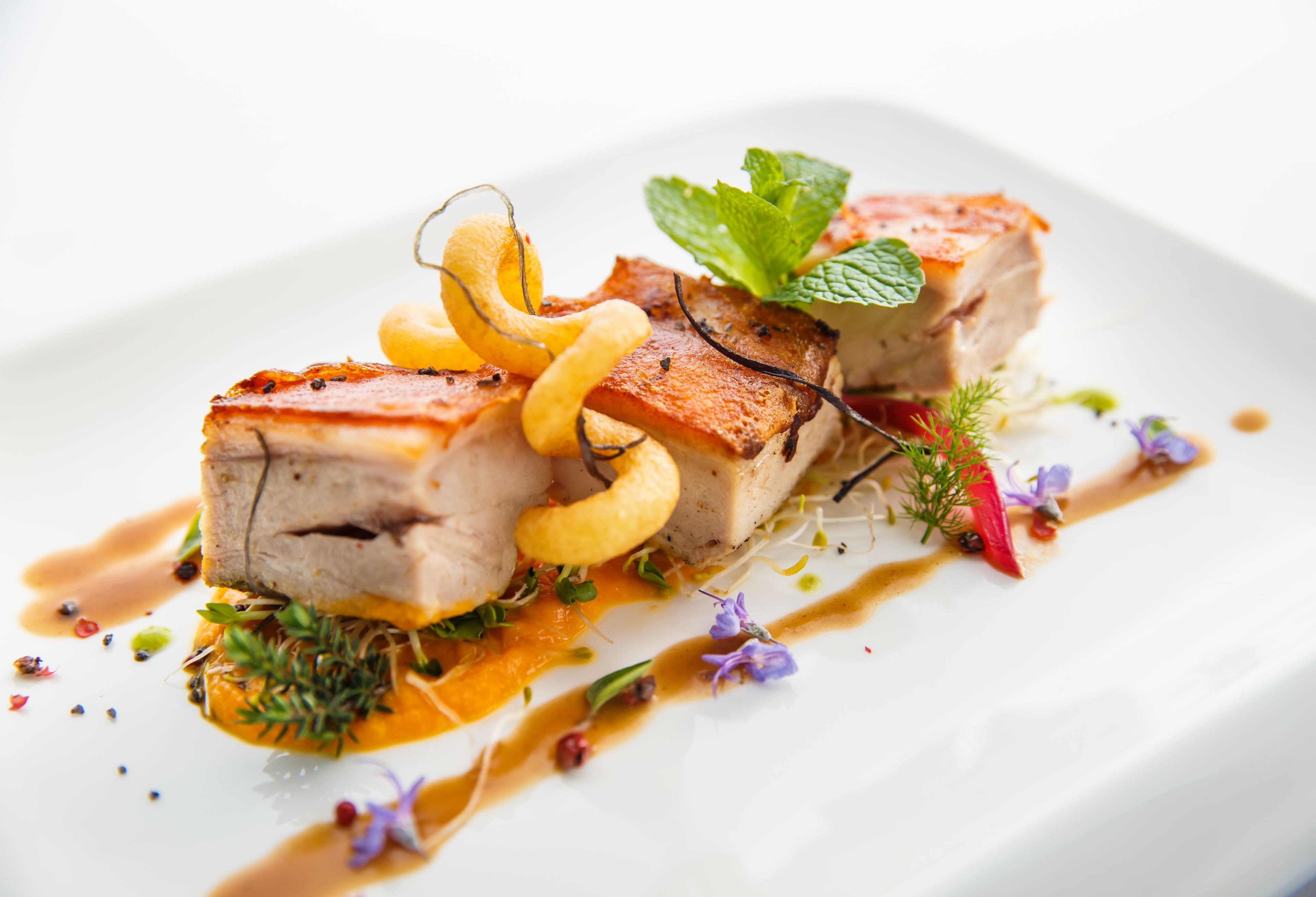 A plated dish with various garnishes and sauces.